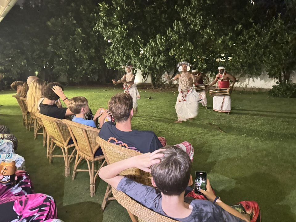 Guests watching an evening performance at the villa