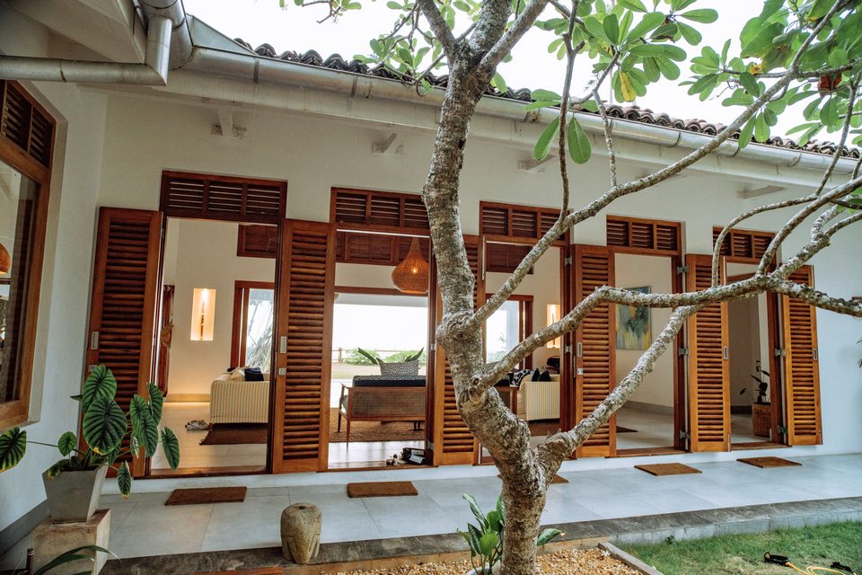 The villa entrance through tropical gardens